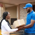 close-up-delivery-person-giving-parcel-client